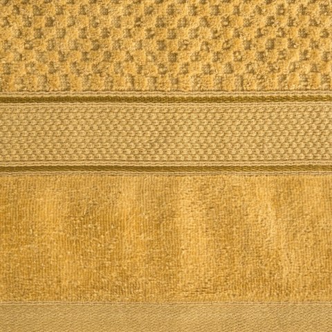 Ręcznik Jessi 50x90 musztardowy frotte 500g/m2 z fakturą wytłaczanej krateczki i welurową bordiurą Eurofirany Ręcznik Jessi 50x90 musztardowy frotte 500g/m2 z fakturą wytłaczanej krateczki i welurową bordiurą Eurofirany